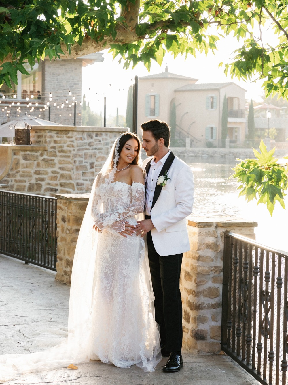 Wedding couple near a red car at an estate
