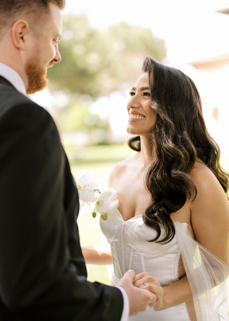 Radiant look between newlyweds showcasing Hollywood waves hair trend and flawless complexion under flattering open shade light.