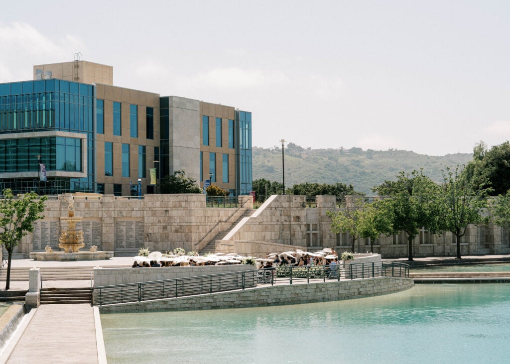 Sun-drenched outdoor wedding ceremony layout with white umbrellas at Soka University, showcasing premium options for wedding venue photography.