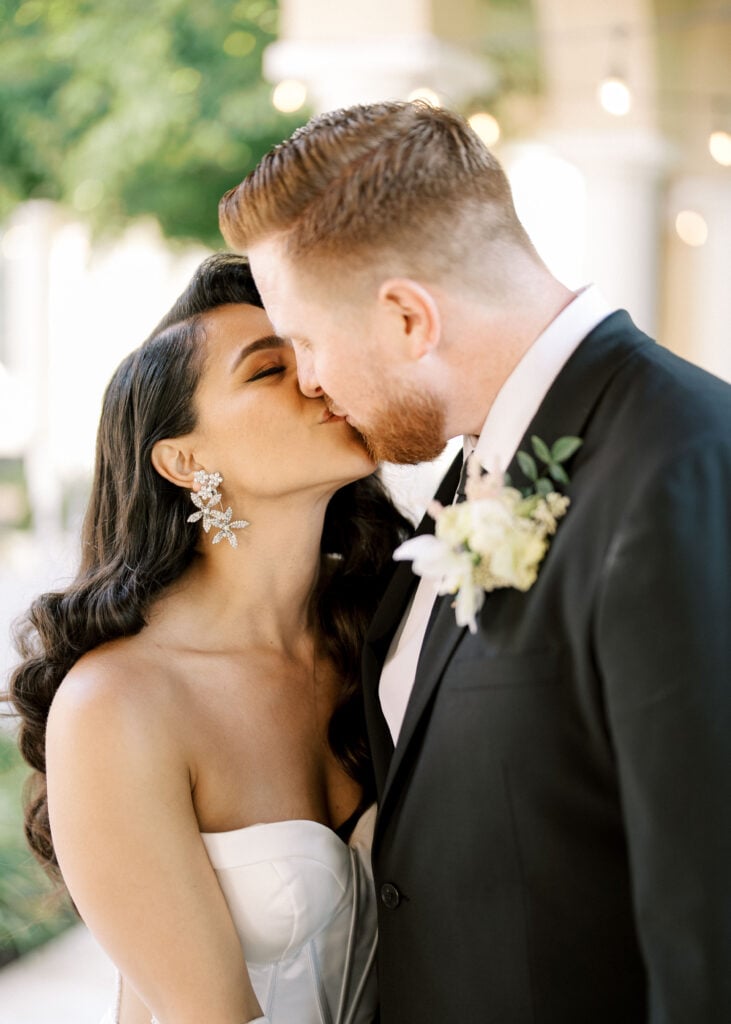 Intimate newlywed kiss at Soka University, illustrating soft open shade lighting secrets that make portraits photograph beautifully.