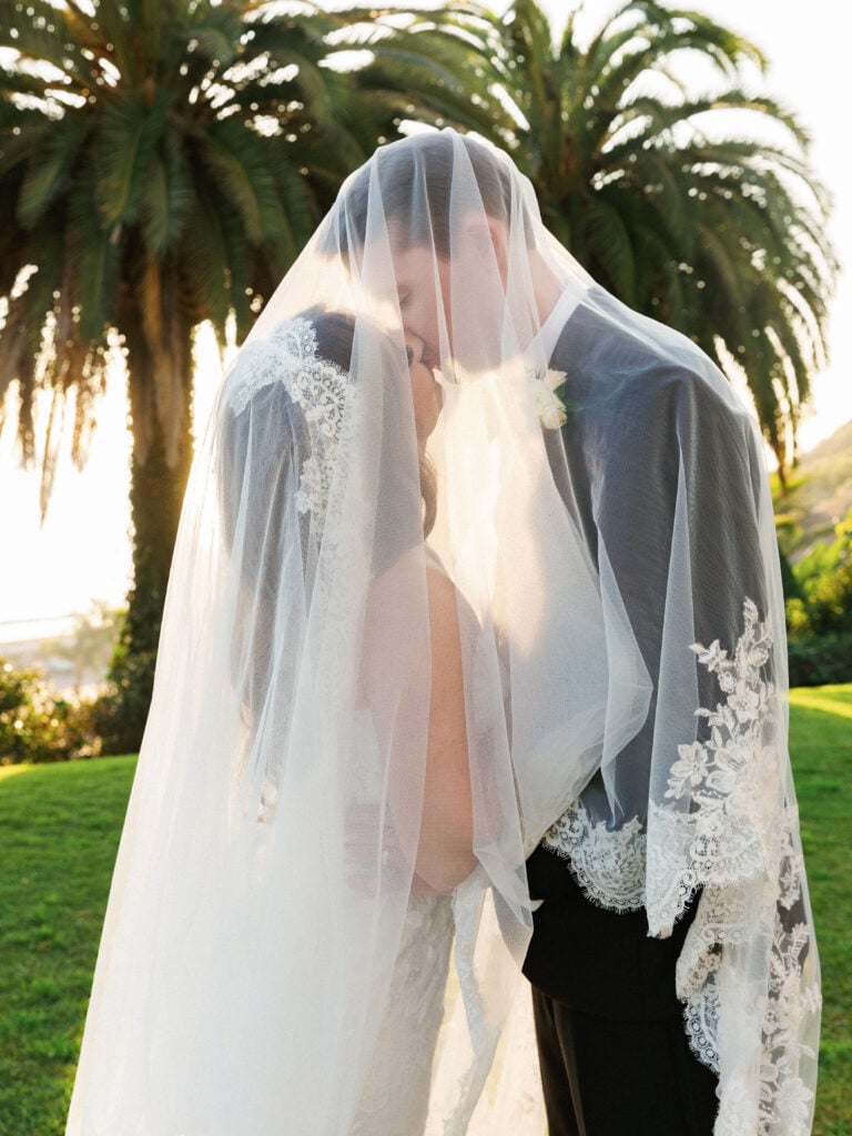 Romantic under-the-veil wedding portrait at a California coastal estate, highlighting soft natural light for editorial wedding venue photography.