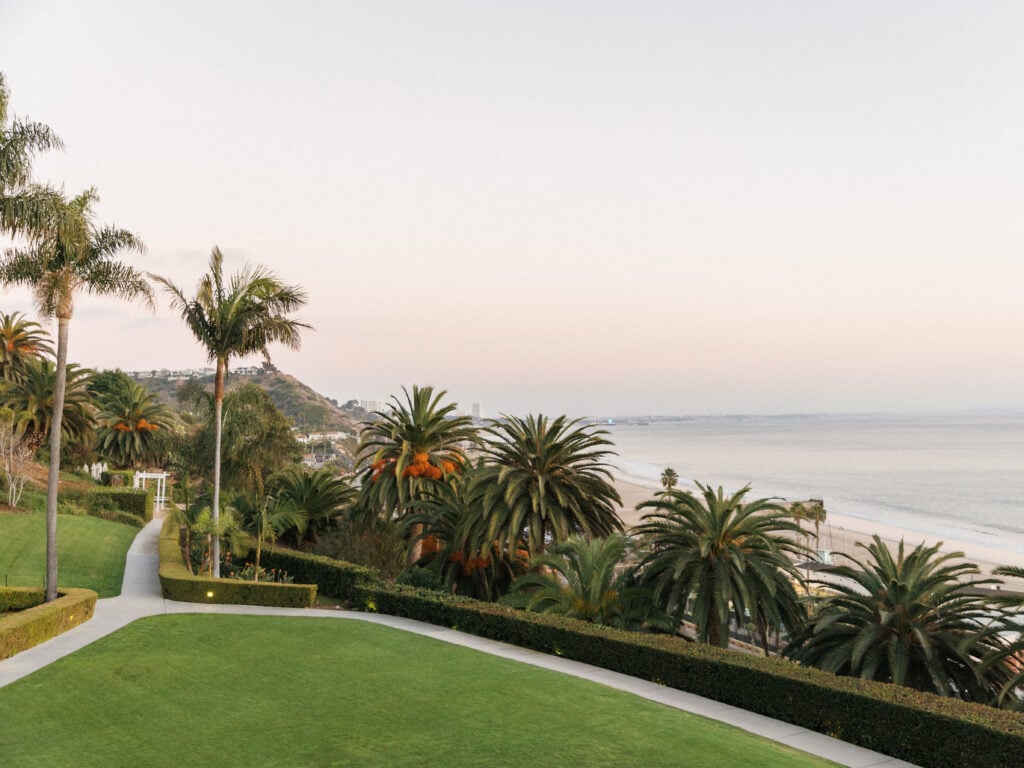 Serene sunset view over Malibu coast from the terraced lawn at Bel-Air Bay Club, showcasing dream destinations for coastal wedding venue photography.