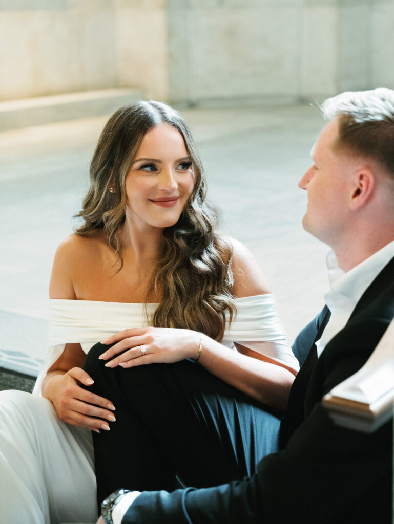 Candid wedding photo ideas capturing a tender, loving glance between a sophisticated groom and his bride during portraits.