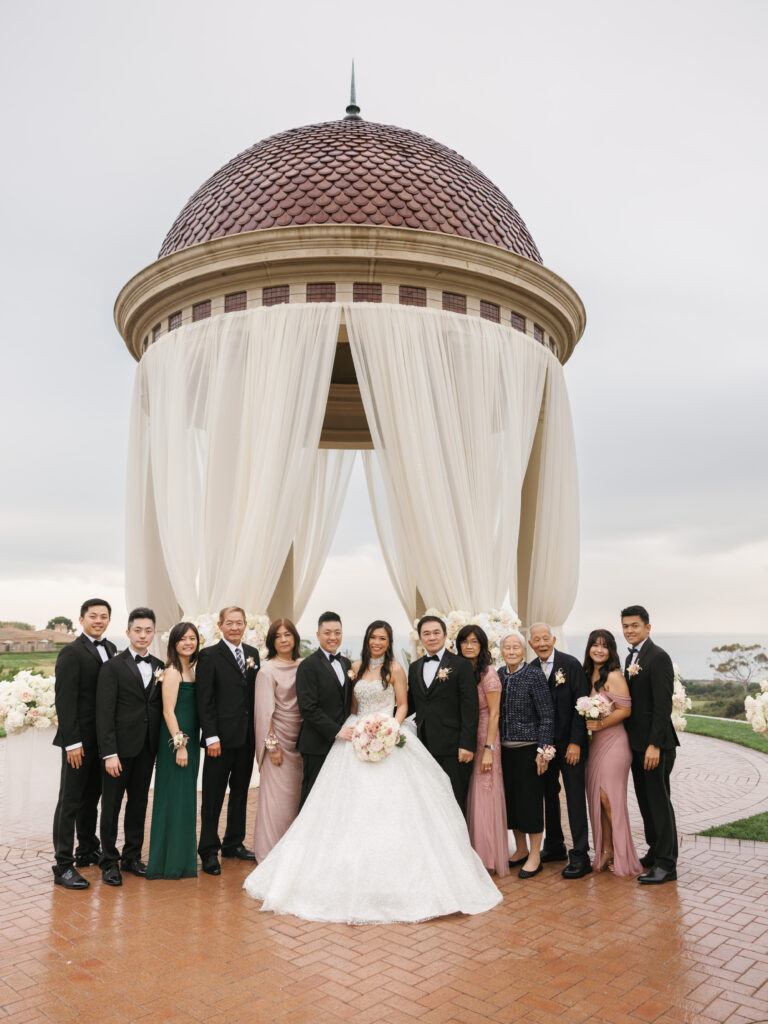 Sophisticated multi-generational family wedding portraits at The Resort at Pelican Hill, captured beautifully under soft cloudy skies.