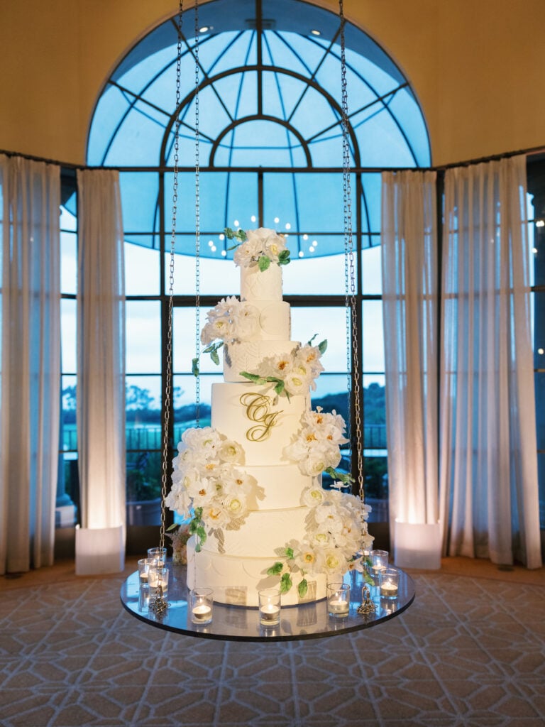 Exquisite five-tier suspended wedding cake design with monogram details, capturing a luxury indoor wedding rain plan reception aesthetic.