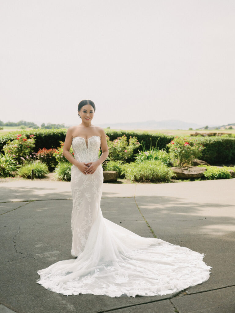 Stunning bridal portrait on film showcasing a lace strapless wedding gown with a dramatic circular train, taken by a Napa Valley wedding photographer.