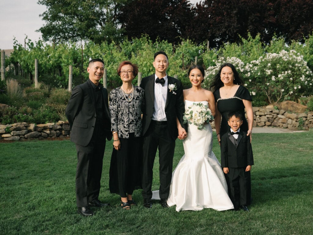 Formal wedding family portraits taken on film by a Napa Valley wedding photographer, featuring the bride, groom, and smiling family members.