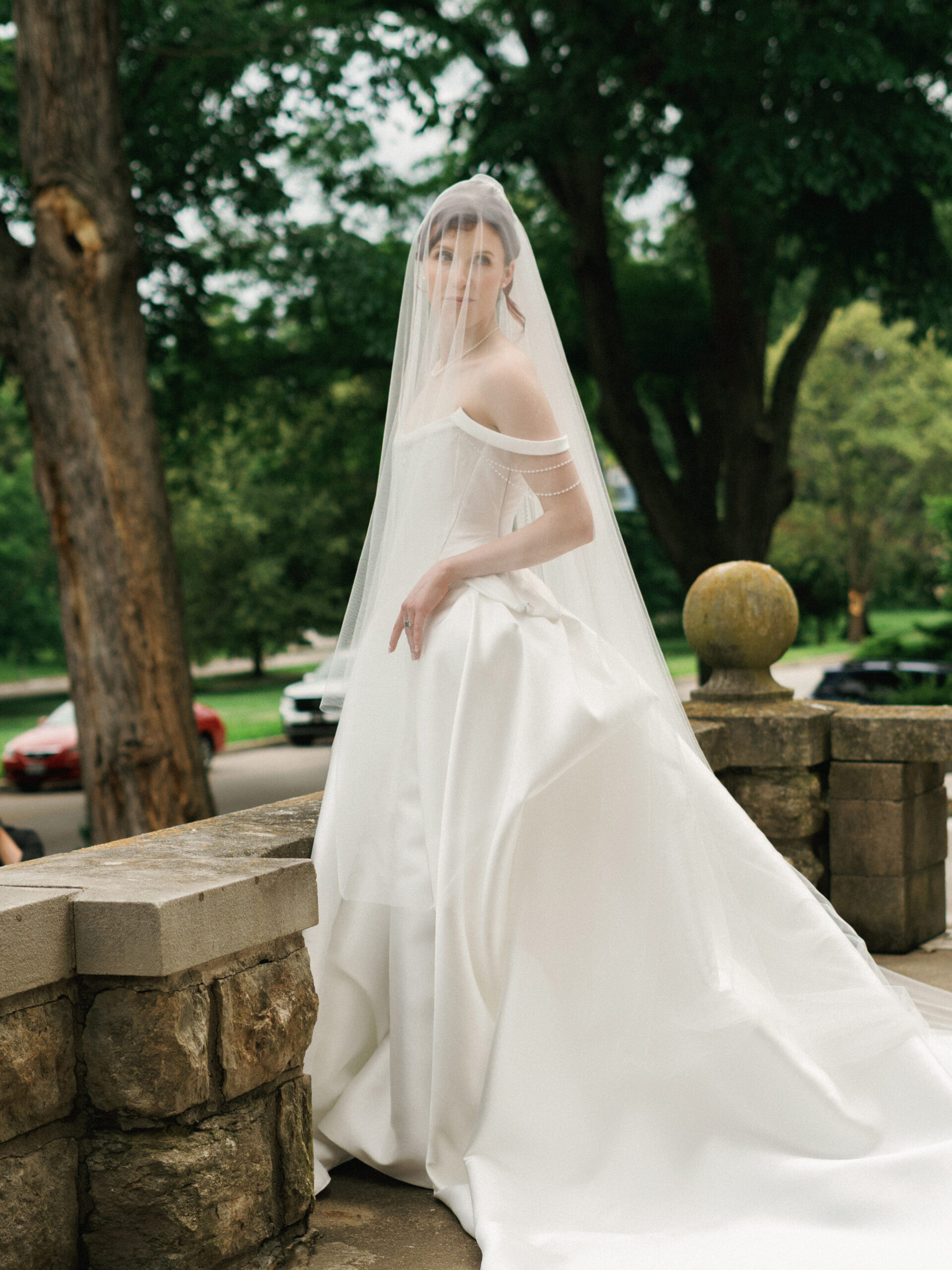 Editorial outdoor wedding photo ideas featuring a stunning bride in a voluminous ballgown at a scenic vintage estate.