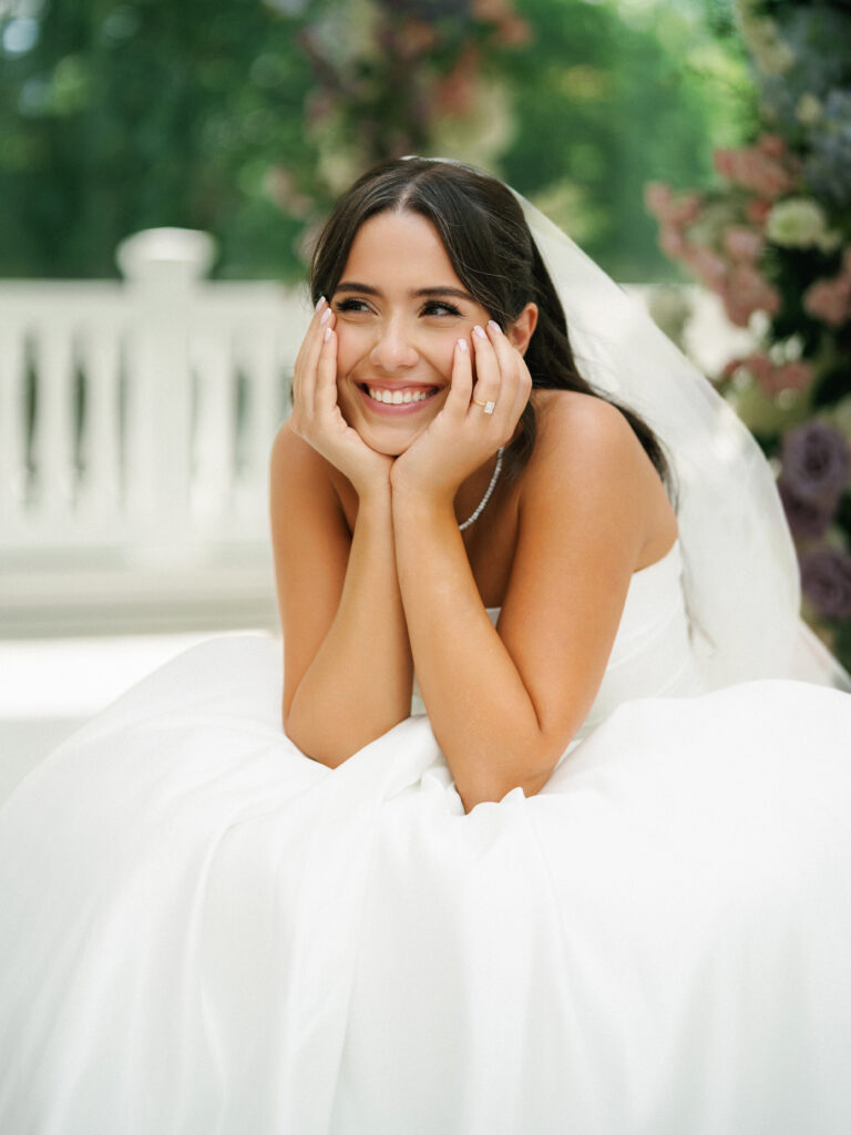 Intimate bridal wedding photo ideas capturing a stunning bride laughing, highlighting her diamond engagement ring and tennis necklace.