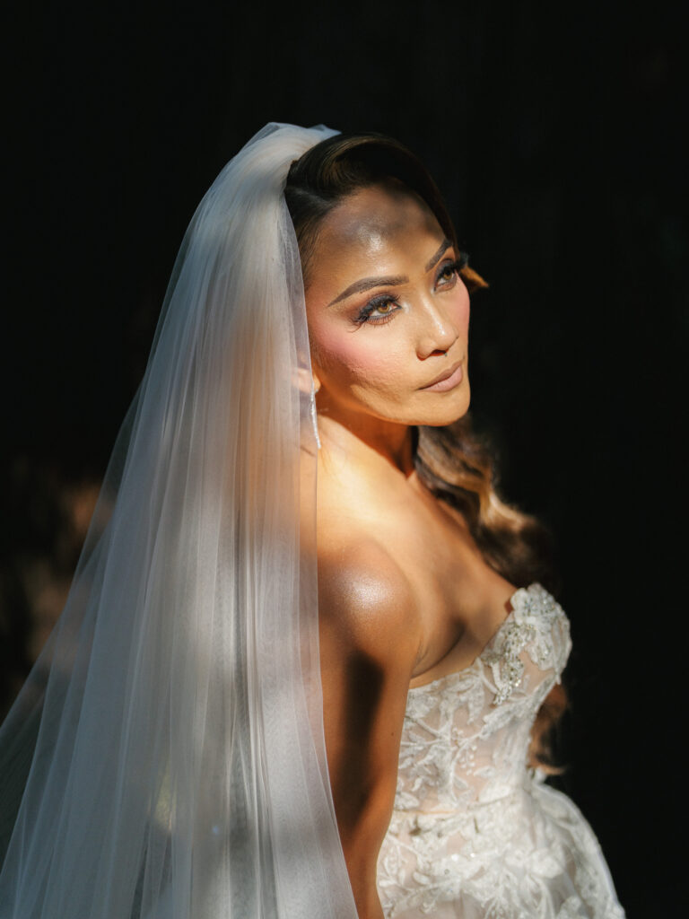 Close up bridal portrait with high contrast shadow and light filtering through trees captured by a Big Sur wedding photographer