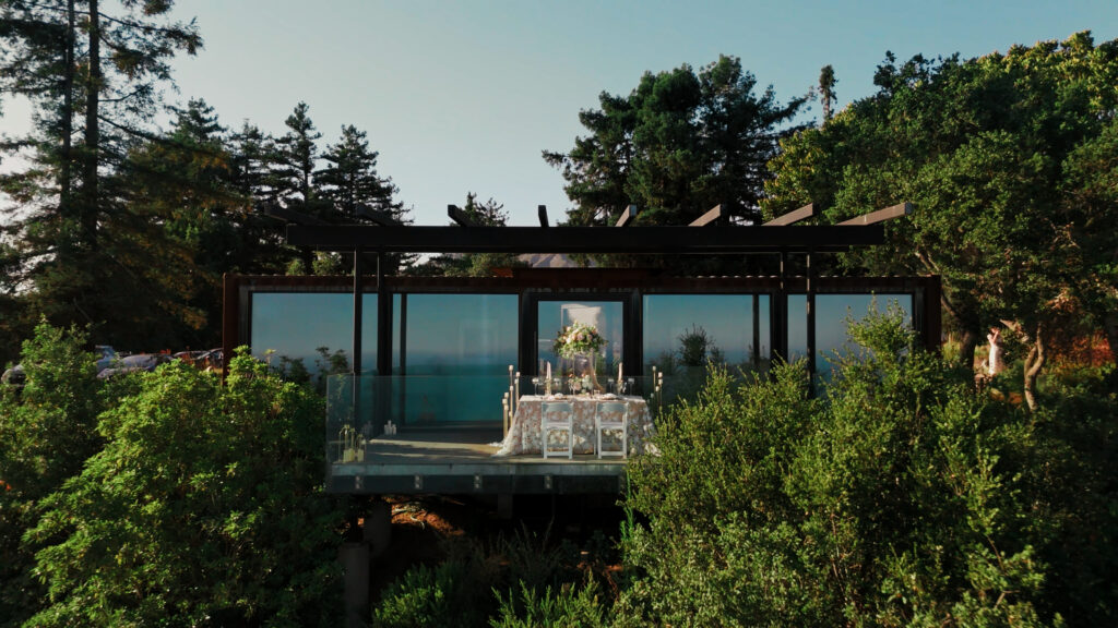 Modern shipping container wedding venue with a glass balcony overlooking the ocean captured by a Big Sur wedding photographer