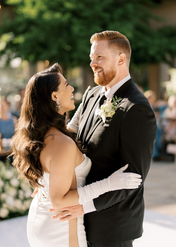 Close up look at a happy bride and groom holding each other during their wedding first dance