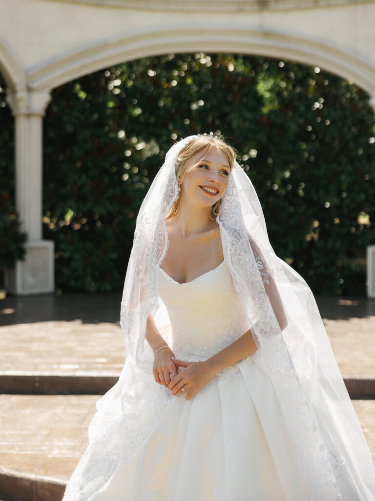 Shaded venue areas providing heat protection for a beautiful bride during her outdoor wedding portrait session