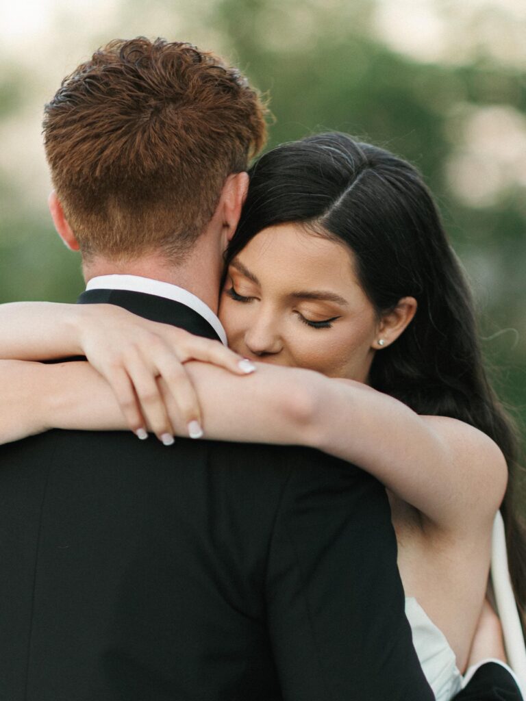 Close up shot of an emotional bride closing her eyes during an intimate wedding first dance moment